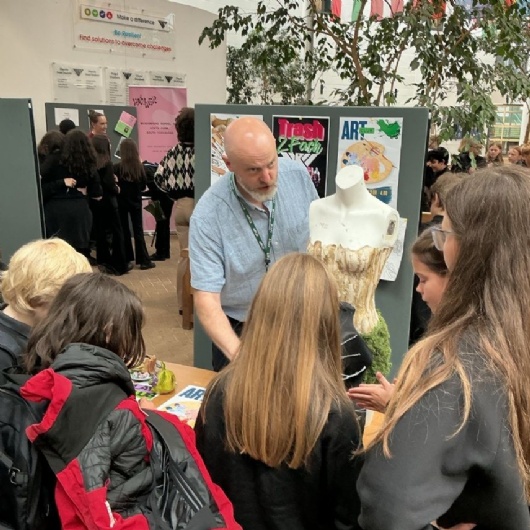 students chat to a teacher about after school activities
